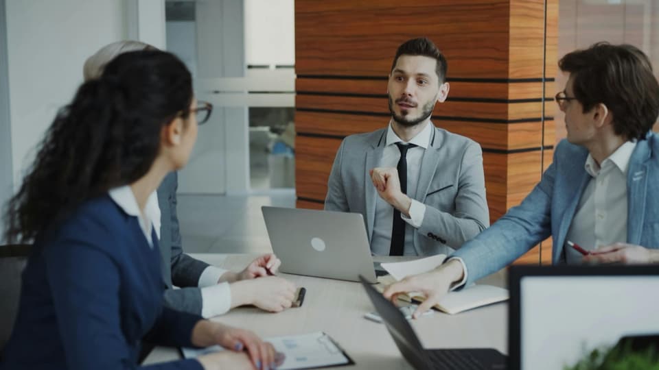 Business professionals collaborating at a meeting in a modern office