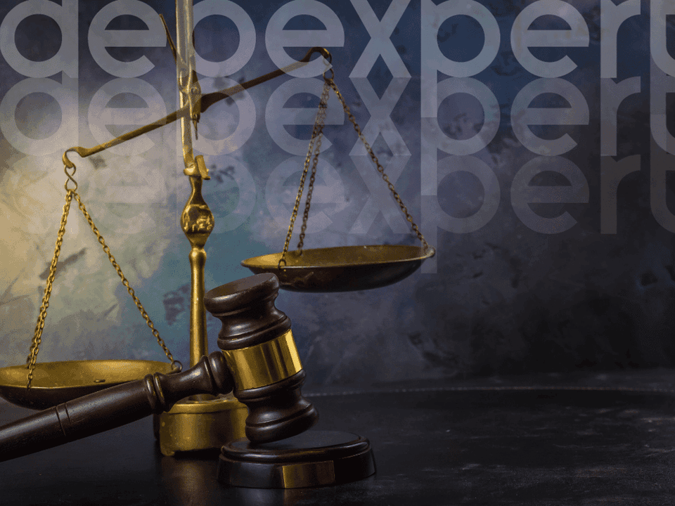 65296f66db4c9bb4ec901fe4_Judge-s-hammer-and-scales-on-the-table.png